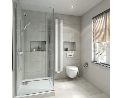Salle de bain lumineuse avec douche, radiateur et toilettes