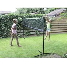 Deux enfants jouent avec un filet dans le jardin.