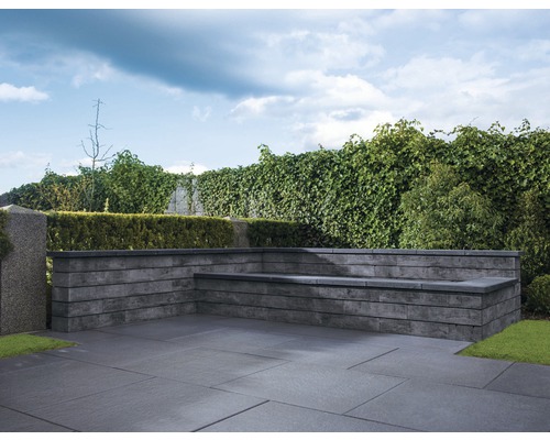 Aussenbereich mit Pflastersteinen und Gartenbank aus Stein