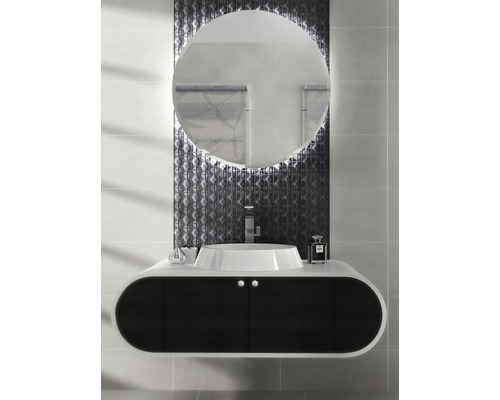 Salle de bains moderne avec miroir rond, lavabo et meuble bas foncé.