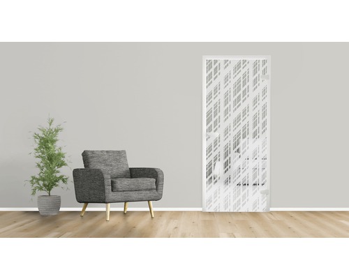 Dekorative Innentür mit geometrischem Muster, Sessel und Zimmerpflanze in einem Wohnraum.