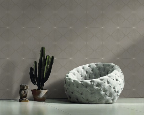 Salon avec papier peint à motifs, fauteuil, cactus et figurine décorative