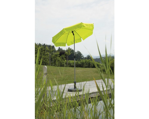 Geöffneter, grüner Sonnenschirm im Garten.
