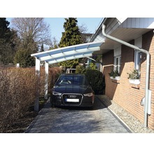 Voiture garée sous un abri d''auto à côté d''une maison