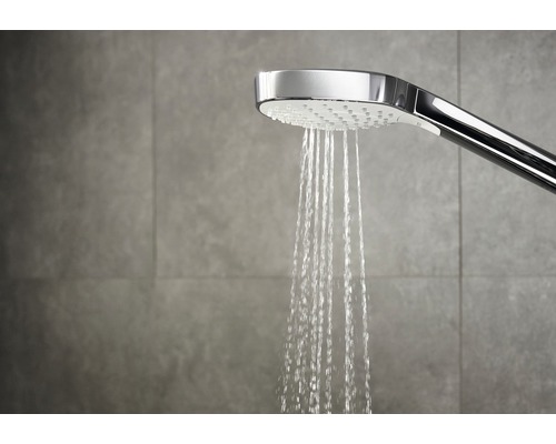 Handbrause mit fließendem Wasser im Badezimmer