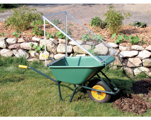 Grüne Schubkarre mit Metallsieb im Garten