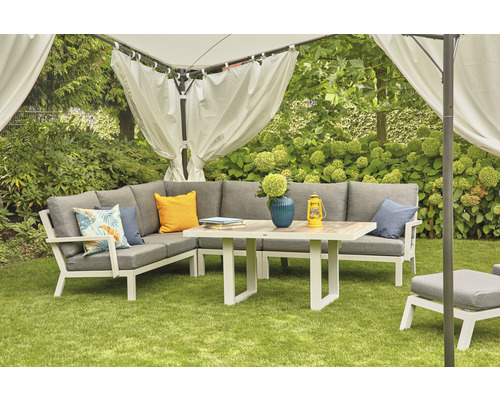 Scène de jardin avec canapé d''angle, table et pavillon sur pelouse