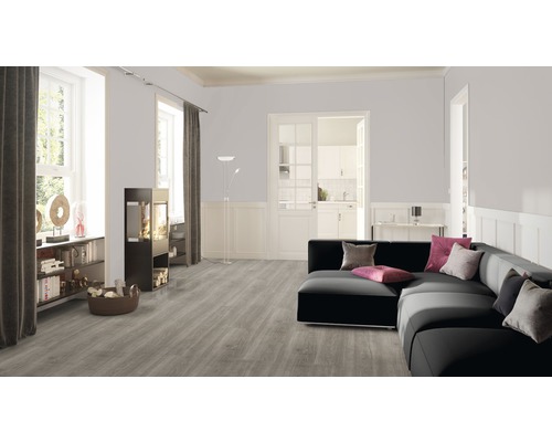 Salon avec sol en vinyle gris, canapé noir et cheminée