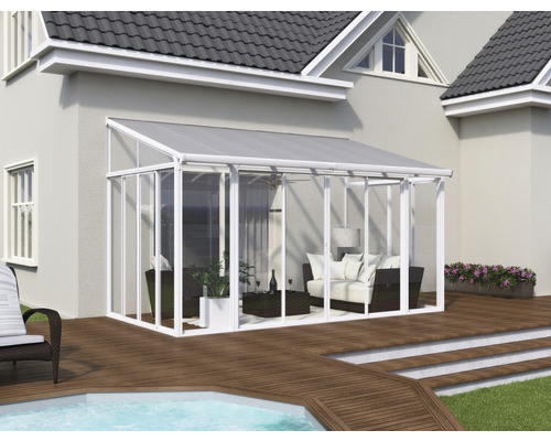 Jardin d''hiver attenant avec mobilier de patio sur une terrasse en bois à côté d''une maison.