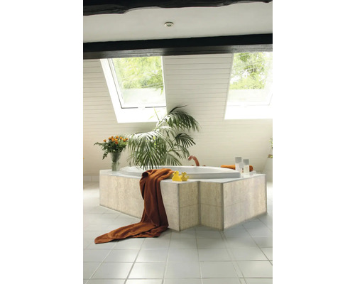 Salle de bain avec baignoire, serviette, canards en caoutchouc, plante, fleurs et fenêtre de toit