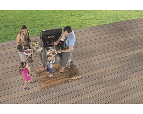 Familie grillt auf einer Terrasse mit Grillmatte und Grill