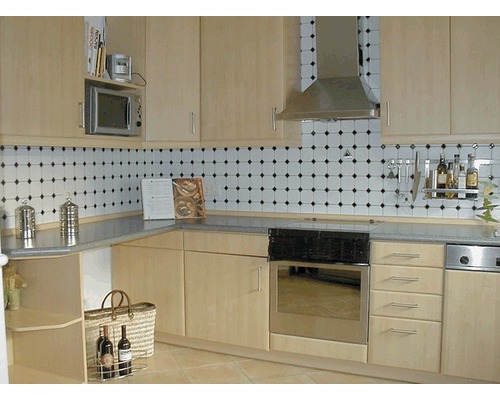 Vue de cuisine avec placards intégrés, évier, cuisinière et hotte aspirante