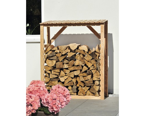 Étagère à bois remplie de bois de chauffage dans le jardin