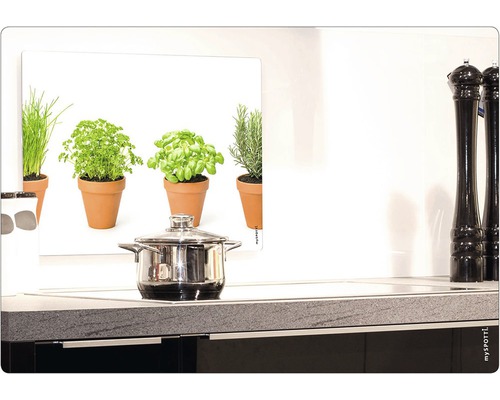 Küchenszene mit Topf auf Herd und Kräuterbild als Spritzschutz