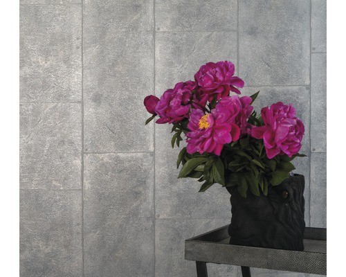 Szene mit grauer Ziegel-Tapete und Blumenarrangement in einer dunklen Vase auf einem Tisch