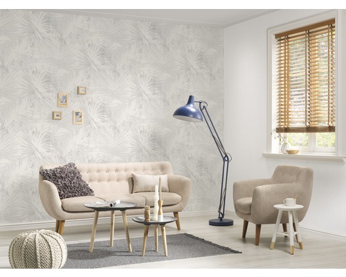 Wohnzimmer mit Sofa, Sessel, Stehlampe und gemusterter Tapete