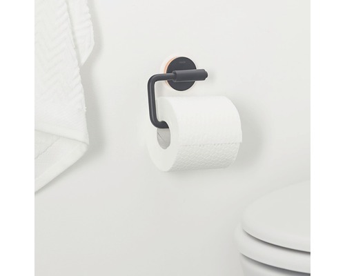 Distributeur de papier toilette avec rouleau de papier toilette sur un mur de salle de bains