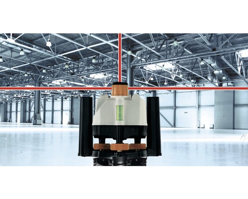 Laser rotatif projetant des lignes laser rouges dans un entrepôt.