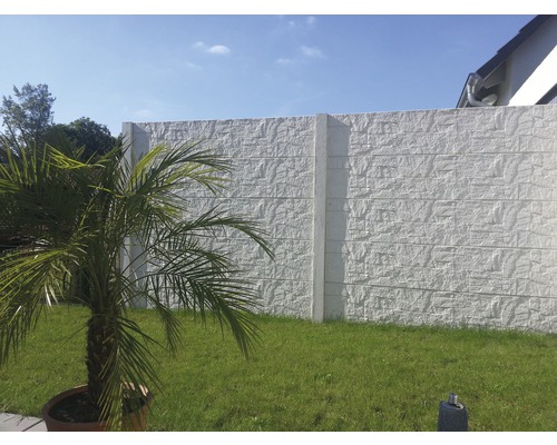 Clôture en béton avec structure à motif de pierre dans le jardin