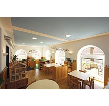 Salle de classe lumineuse avec mobilier en bois et plafond bleu
