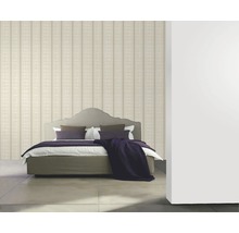 Schlafzimmer mit gestreifter Tapete und Bett