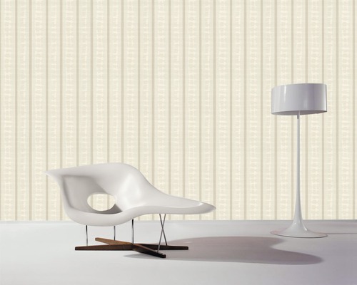 Papier peint à rayures, fauteuil et lampadaire dans une pièce.