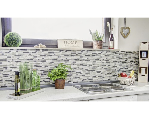 Scène de cuisine avec des carreaux de mosaïque, des herbes aromatiques, des décorations et une cuisinière électrique