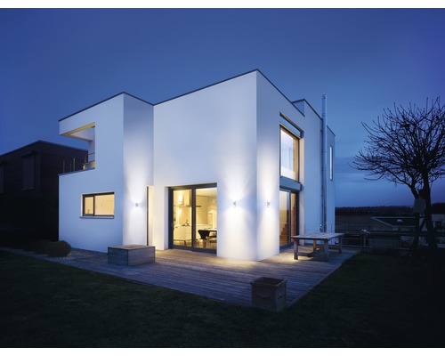 Modernes Haus mit Beleuchtung im Aussenbereich und Holzterrasse