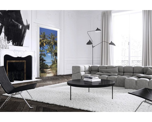 Salon lumineux avec poster de porte représentant un chemin de plage bordé de palmiers