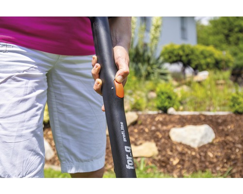 Gros plan d''une personne tenant un manche d''outil de jardin de la marque For Q profi_line avec un bouton orange