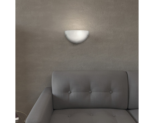 Halbrunde Wandleuchte aus Glas über einem Sofa.