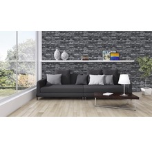 Wohnzimmer mit Backsteintapete, Sofa, Tisch und Dekoration für ein gemütliches Ambiente.
