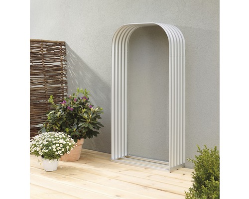 Torrahmen aus Metall auf einer Holzterrasse mit Pflanzen