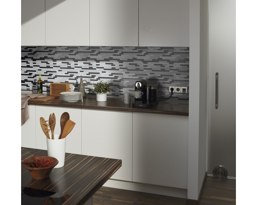 Scène de cuisine avec des carreaux de mosaïque, un plan de travail et des ustensiles de cuisine