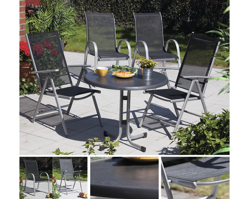 Salon de jardin avec table ronde et quatre chaises à l''extérieur