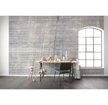 Intérieur avec mur en béton gris, bureau, chaise et grande fenêtre pour une ambiance lumineuse et moderne.