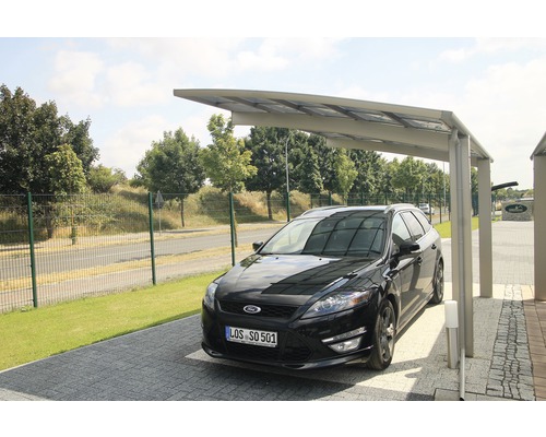 Une voiture est garée sous un abri de voiture.