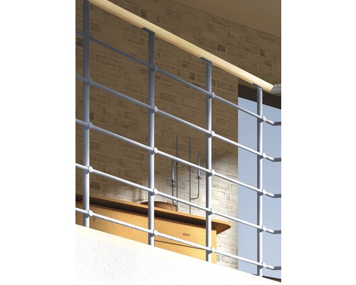 Geländer aus Metall mit Holzhandlauf vor einer Ziegelwand