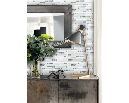 Wandgestaltung mit Mosaikfliesen im modernen Stil mit Spiegel und Lampe auf einem Schrank.