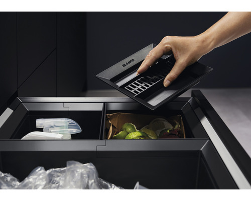 Mülltrennsystem mit Behältern für Wertstoffe, Abfall und Kompost, eine Hand hält einen Einsatz von Blanco.