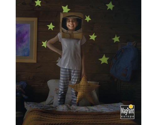 Enfant avec un casque d''astronaute dans une chambre d''enfant avec des motifs d''étoiles et le logo MagPaint Europe.