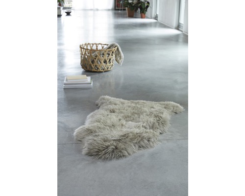 Heller Raum mit Schaffellteppich, Stapel Büchern und Korb