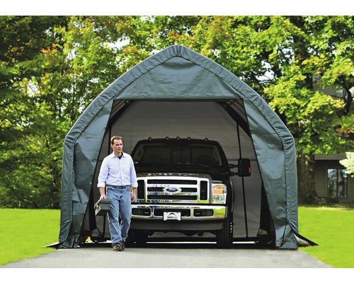 Image d''un carport de garage en toile avec un homme portant une boîte à outils et un pick-up