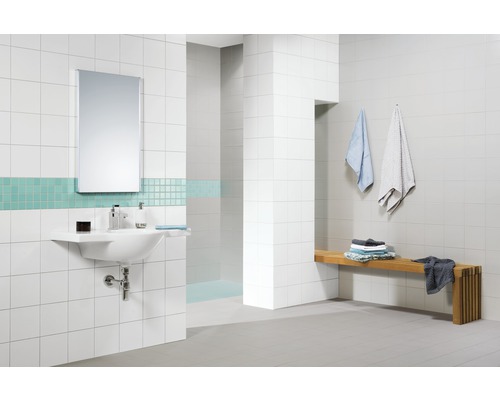 Helles Badezimmer mit Waschbecken, Spiegel, Fliesen und Holzbank