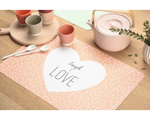 Décoration de table avec assiettes, tasses, théière et set de table avec l''inscription Laugh & Love