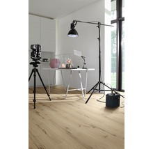Studio de production avec caméra sur trépied, table, lampe et revêtement de sol posé