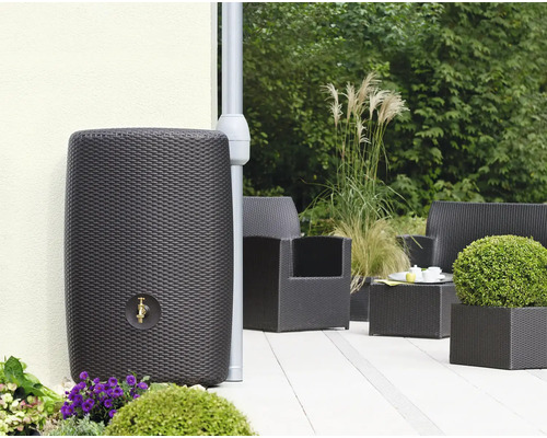 Récupérateur d''eau de pluie aspect rotin avec robinet dans le jardin