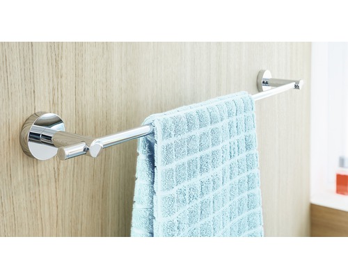 Handtuchhalter aus Chrom mit Handtuch an einer Holzwand