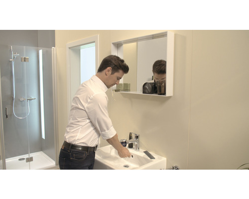 Modernes Badezimmer mit Waschbecken, Spiegel und Dusche.