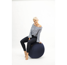 Femme assise sur un ballon de gymnastique.